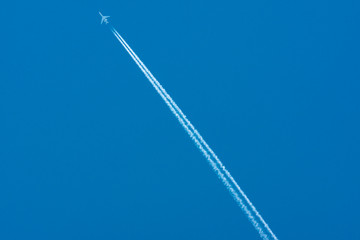 High in the sky flying Tu-134. Blue sky and plane.