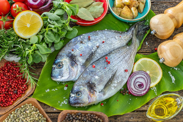 Sea bream ( gilt head ) on the green leaf