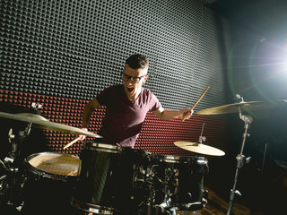 drummer in music studio playing drums