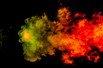 Beautiful horizontal column of smoke in the neon bright light of red, green, yellow and orange on a black background exhaled out of the vape. Nice pattern for printing and backdrop of colored waves.