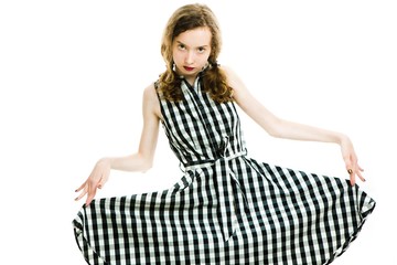 Teen girl in black checkered dress and dark make up posing.