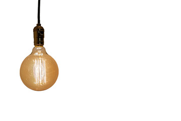 An old vintage light bulb on white background. Old shining glass bulb with orange and yellow light....