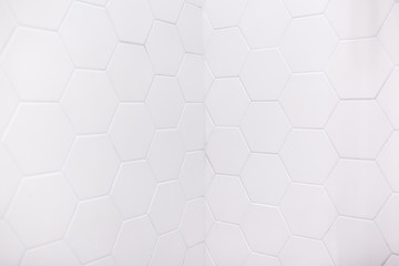 real photo of white hexagonal tiles wall of the bathroom