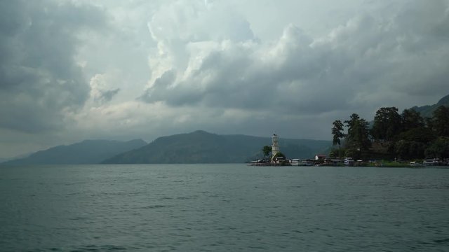 Lake Toba ferry boat ride to get to Samosir island from Parapat to Tuk Tuk (Beautiful clouds and mountains in the background). Seq 2