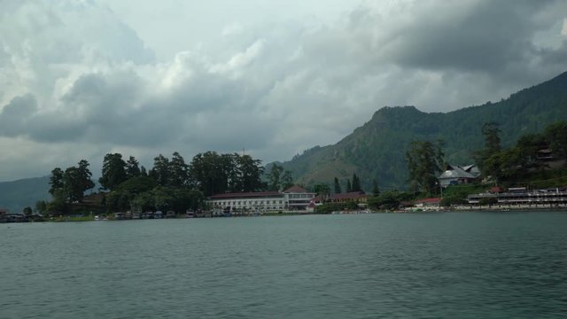 Lake Toba ferry boat ride to get to Samosir island from Parapat to Tuk Tuk (Beautiful clouds and mountains in the background). Seq 1
