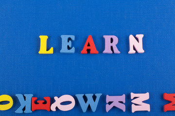 LEARN word on blue background composed from colorful abc alphabet block wooden letters, copy space for ad text. Learning english concept.