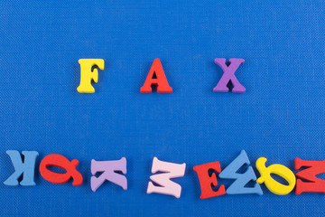FAX word on blue background composed from colorful abc alphabet block wooden letters, copy space for ad text. Learning english concept.
