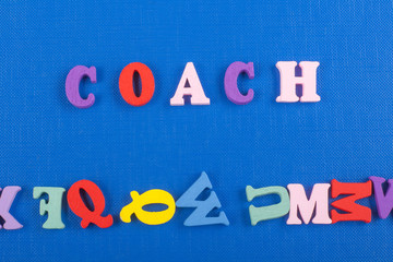 COACH word on blue background composed from colorful abc alphabet block wooden letters, copy space for ad text. Learning english concept.