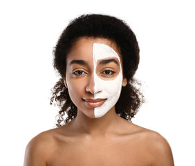 Young African-American woman with mask on half of her face against white background