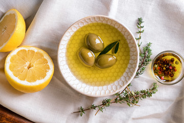 Bowl with tasty olive oil on table