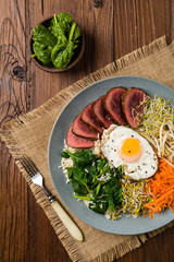 Fototapeta na wymiar Korean beef with sprouts, spinach and fried egg.