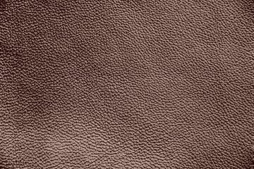 Fototapeta premium The texture of genuine leather. Impeccable and stylish background. Beautiful stylish background. Natural skin texture close up. Brown background. The structure of the leather material brown shades.