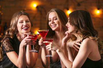 Beautiful young women with cocktails at party
