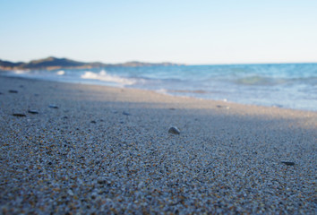 Canary Islands nature. Black sea round stones on the sandy coast close up.