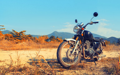 Obraz premium Aged motorbike under sky with digital color picture photo effect