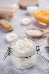 Jar with body scrub on table