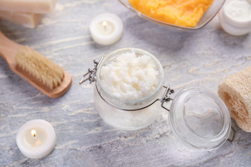 Jar with body scrub on table