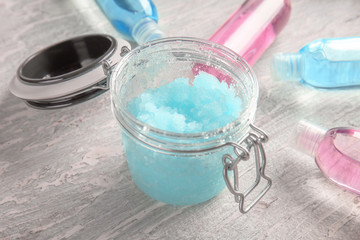 Jar with body scrub on table
