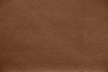 The texture of genuine leather. Impeccable and stylish background.  Beautiful stylish background. Natural skin texture close up. Brown background.  The structure of the leather material brown shades.