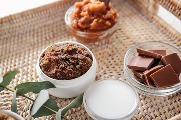 Bowls with body scrub and ingredients in wicker tray