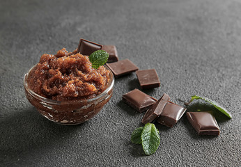 Bowl with chocolate body scrub on table