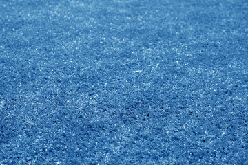 Artificial grass football field loan with blur effect in navy blue tone.