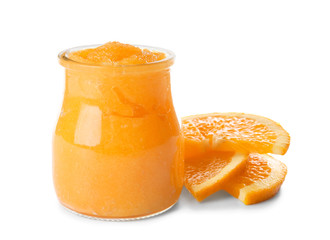 Jar with orange body scrub on white background