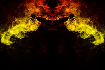 Abstract image of smoke of different green, yellow, orange and red colors in the form of horror in...