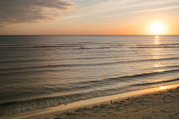 Very beautiful view of the sea coast at sunset. The Baltic Sea is washed by a sea wave.