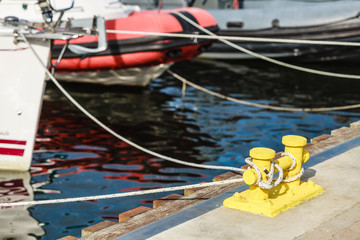 Mooring bollard with rope on pier by the sea