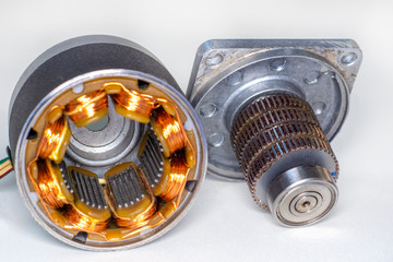 Stepper motor, disassembled, with the rotor set aside Stepper motor with power cable attached, on...