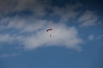 Fototapeta na wymiar Skydive, people in the sky, under clouds