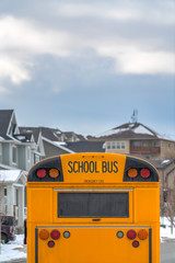 Yellow school bus with rectangular window and several signal lights at the rear
