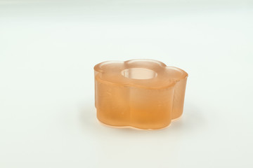 This is a capture for an orange candle holder the picture taken in a studio light and a white background 