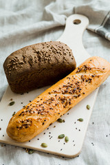 Freshly baked white and grey bread on dark grey fabric with seed