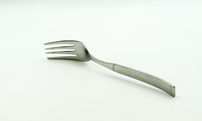 This is a capture of an old Aluminium fork in a studio lighting and a white background  