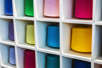 different colors of thread, textile, for clothing manufacture or in the shop