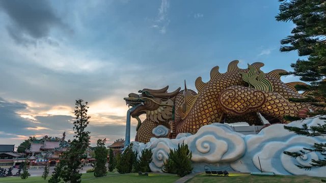 timelapse sunset at Dragon descendants museum in Suphanburi. the big golden dragon is a famous landmark in Suphanburi city .can see from destination tourists like to visit this museum,