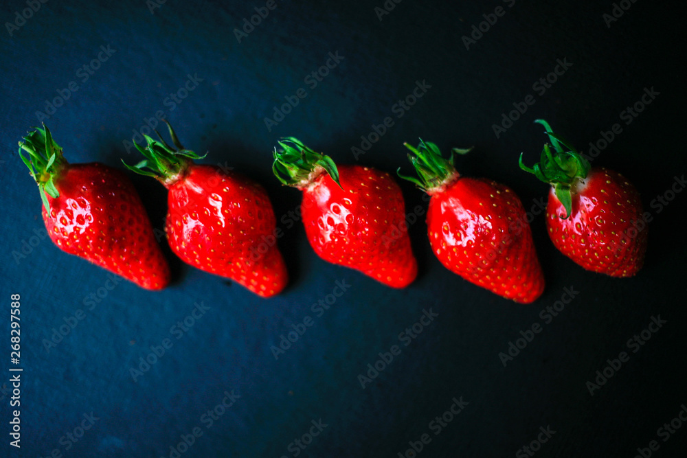 Wall mural group of delicious strawberrys on black background