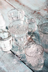 Glasses full of water for the refreshment on a hot summer day. Rain water on a table