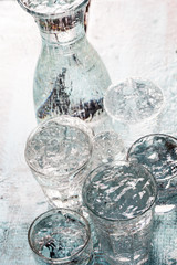 Glasses full of water for the refreshment on a hot summer day. Rain water on a table