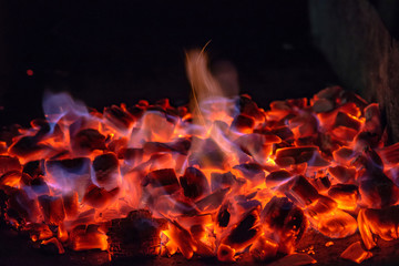 BBQ Grill Pit With Glowing And Flaming Hot Charcoal Briquettes, Food Background Or Texture, Close-Up, Top View