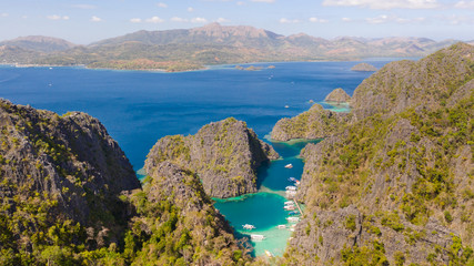 Twin Lagoon in Coron, Palawan, Philippines. Mountain and Sea. Lonely Boat aerial view