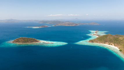 Fototapeta na wymiar aerial seascape Lagoons with blue, azure water in middle of small islands. Palawan, Philippines. tropical islands with blue lagoons, coral reef. Islands of the Malayan archipelago with turquoise