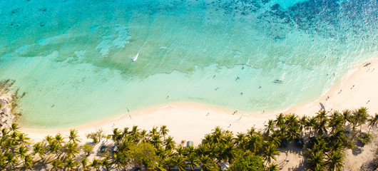 aerial seascape tourists enjoy the tropical beach. tropical island with sand beach, palm trees. Malcapuya, Philippines, Palawan. Tropical landscape with blue lagoon, coral reef