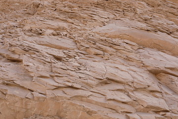 Texture of stone mountain in the desert of Egypt. Great for creative background in pastel colors. Natural textured stone background in light beige color. 