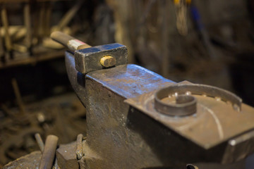 Blacksmith hammer and anvil at forge, workshop. Handmade, craftsmanship and blacksmithing concept