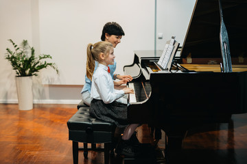 playing piano with teachers help © cherryandbees