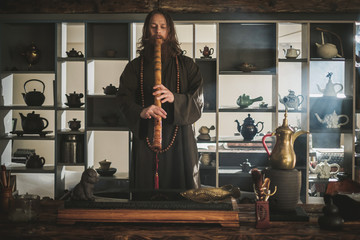 Tea master playing flute before tea ceremony © Nejron Photo
