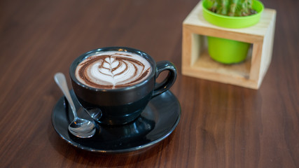 cup of coffee on wooden table